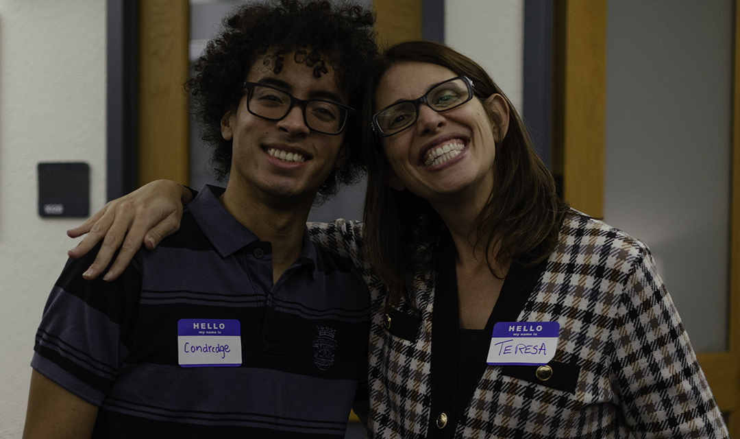 student and professor pose for photo